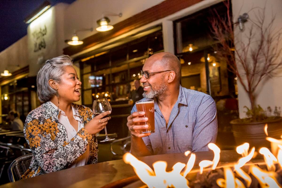 Couple by Fire Pit at Wicked Weed Brewing Couple by Fire Pit at Wicked Weed Brewing