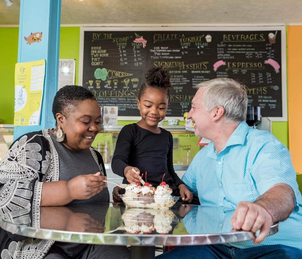 A family enjoys delicious ice cream at The Hop Ice Cream Cafe in Asheville, NC A family enjoys delicious ice cream at The Hop Ice Cream Cafe in Asheville, NC