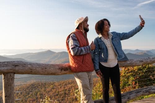 Two visitors take a selfie on the Blue Ridge Parkway near Asheville, NC Two visitors take a selfie on the Blue Ridge Parkway near Asheville, NC