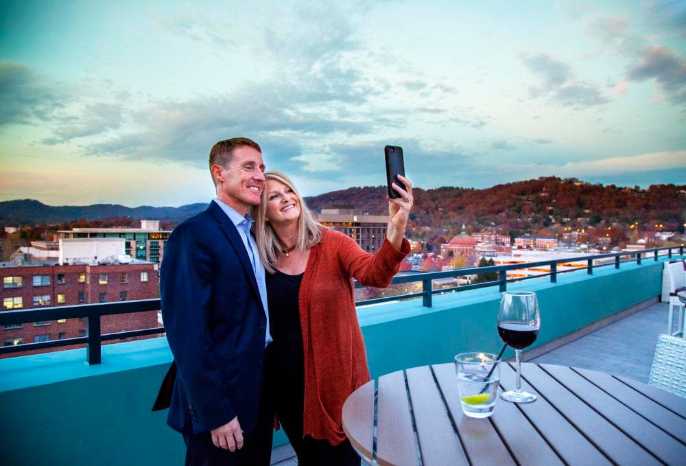 Couple Taking Selfie Photo from Rooftop Lounge in Downtown Asheville Couple Taking Selfie Photo from Rooftop Lounge in Downtown Asheville
