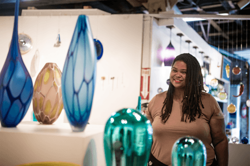 a person looking at handblown glass sculptures a person looking at handblown glass sculptures