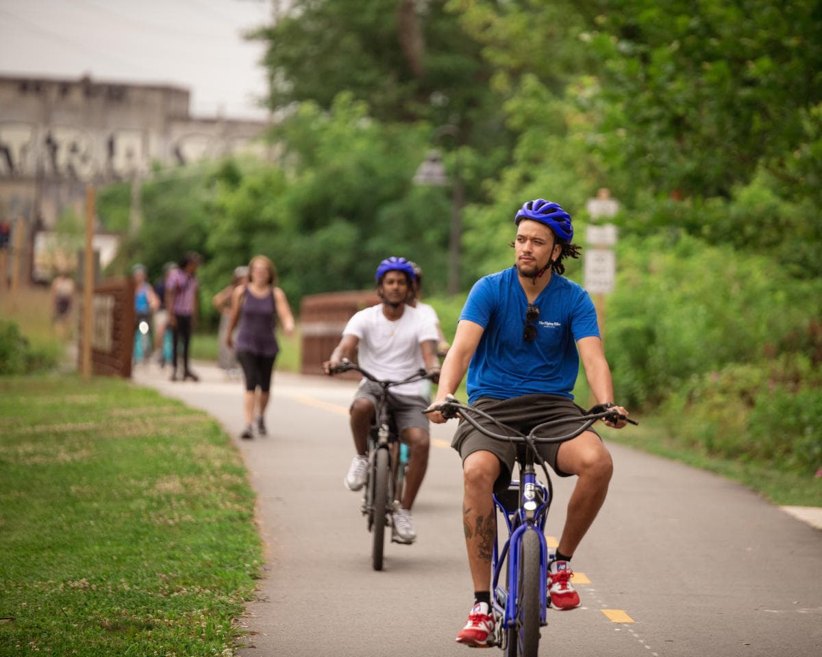 Two men riding bikes along the greenway in Asheville Two men riding bikes along the greenway in Asheville