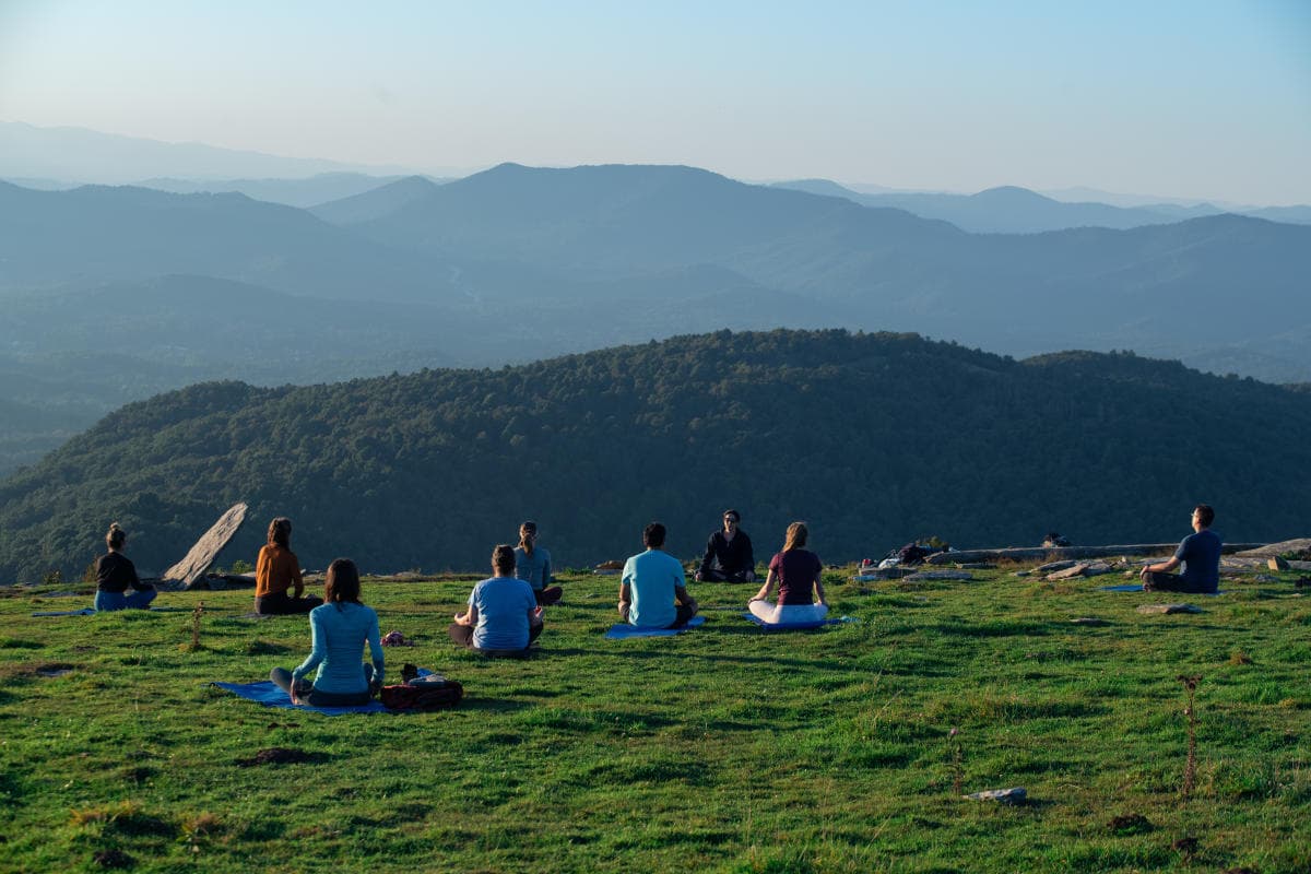 People doing mountaintop yoga on Bearwallow Mountain People doing mountaintop yoga on Bearwallow Mountain