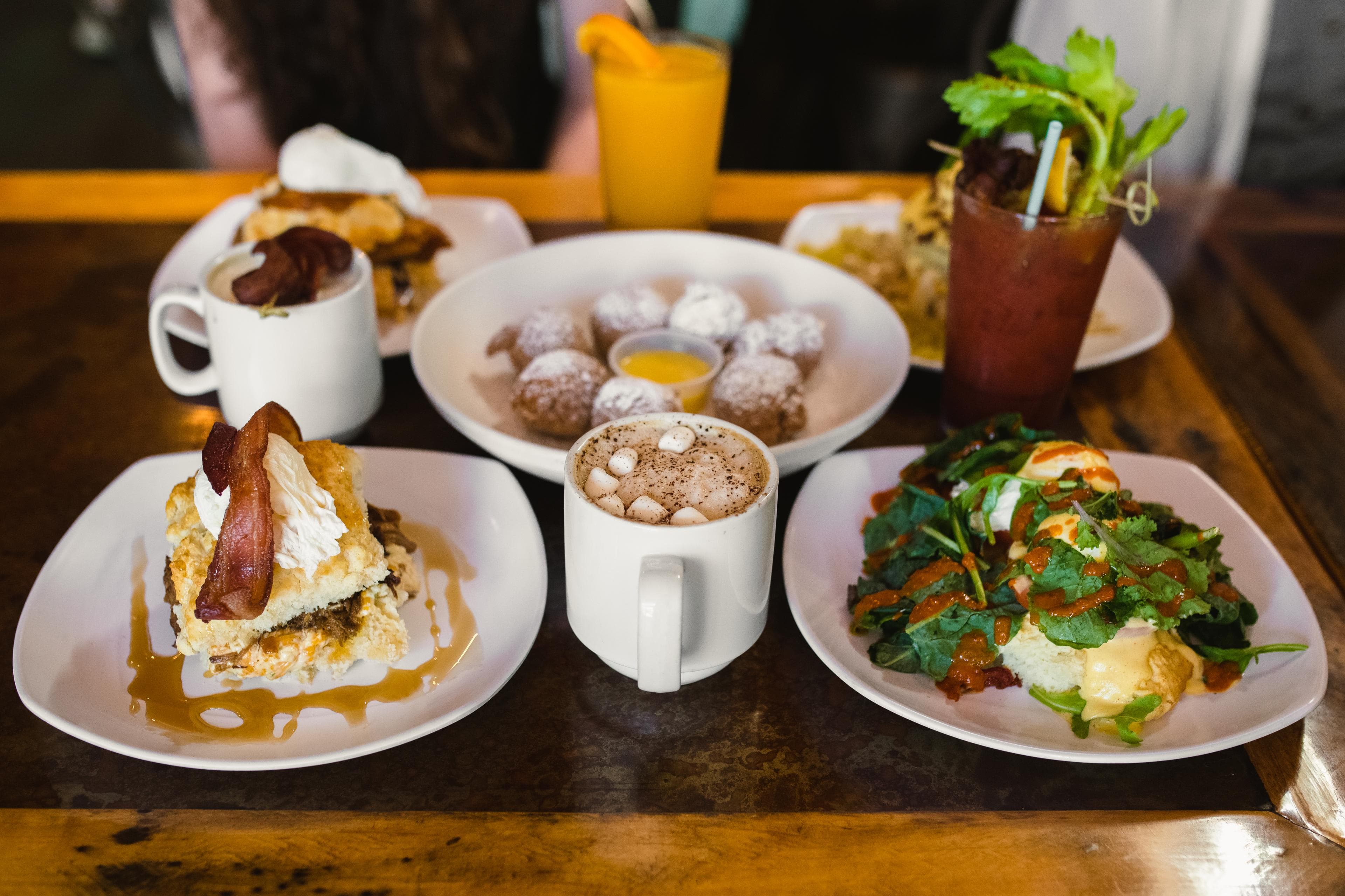 Where to Eat Brunch in Asheville An omelette, powdered donuts, coffee and other brunch items are beautifully displayed on a table at a restaurant in Asheville