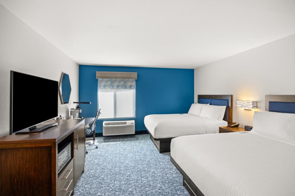 Step inside your retreat near the Blue Ridge Mountains! This image showcases the clean, modern, and comfortable design of a guest room at the Holiday Inn Express Asheville - Woodfin.
Our rooms are designed for a great night’s sleep and effortless productivity. Notice the plush bedding on the premium mattress, promising a restful stay. You'll also see the spacious work area with a desk and free high-speed Wi-Fi, making it easy to stay connected, whether you’re working remotely or planning your A Step inside your retreat near the Blue Ridge Mountains! This image showcases the clean, modern, and comfortable design of a guest room at the Holiday Inn Express Asheville - Woodfin.
Our rooms are designed for a great night’s sleep and effortless productivity. Notice the plush bedding on the premium mattress, promising a restful stay. You'll also see the spacious work area with a desk and free high-speed Wi-Fi, making it easy to stay connected, whether you’re working remotely or planning your A